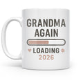 White mug with Grandma Again Loading 2026 lettering, a progress bar, and small pastel accents