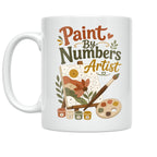 White Paint By Numbers Artist ceramic mug with a floral canvas, paintbrushes, palette and numbered paint pots